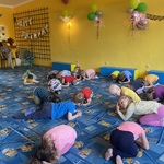 Dzieci leżą zwinięte w kłębek na dywanie.JPG